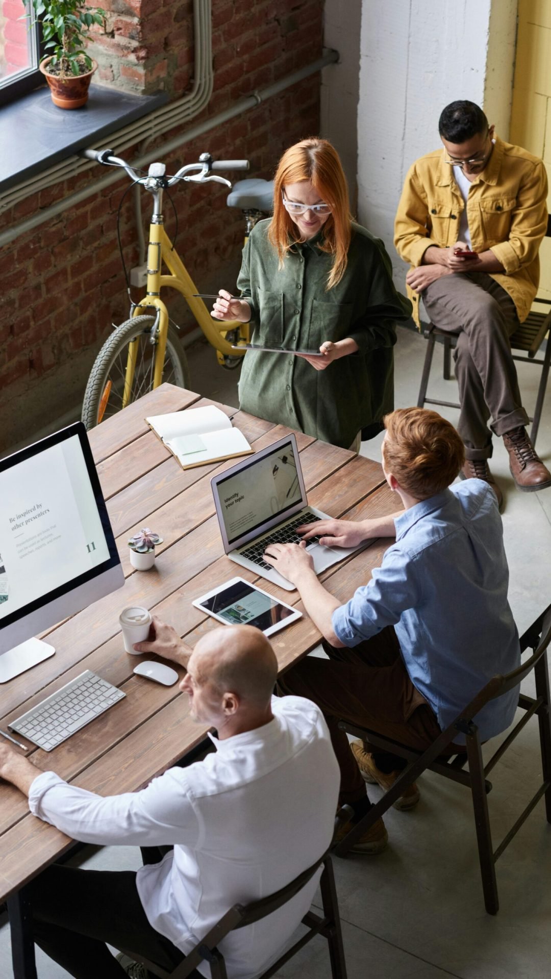 Casual workspace with diverse team working and interacting in a modern office.